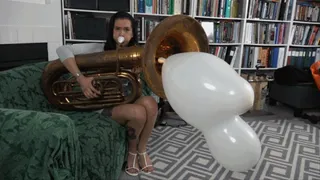 Maria Blows a Mouse Figurine Balloon Out of Her Tuba