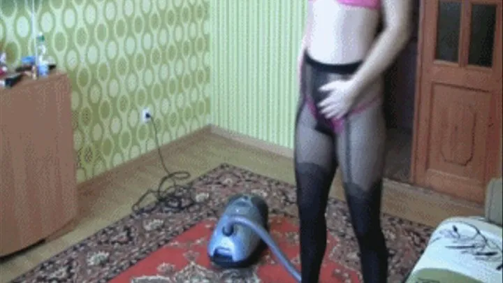 Cleaning by the vacuum cleaner in black stockings a