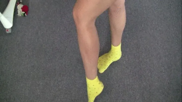 Strong muscles of legs and a leg in yellow socks.