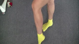 Strong muscles of legs and a leg in yellow socks