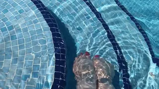 Wiggling toes and splashing feet in pool