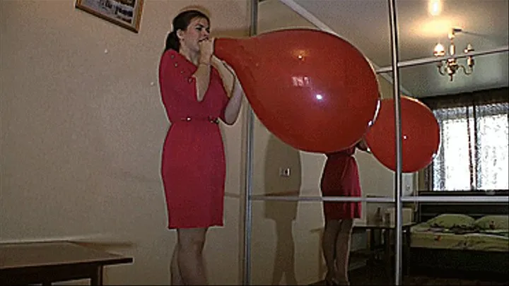 Red BTP in a red dress at the mirror.