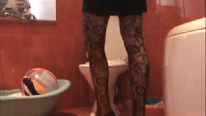 Toilet clip with black dress, stockings and high heels on