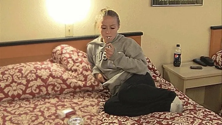 Ashley smokes on the bed