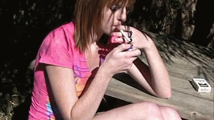 Kate smokes outdoors