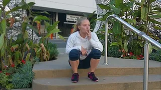 Ashley smoking outside the theater