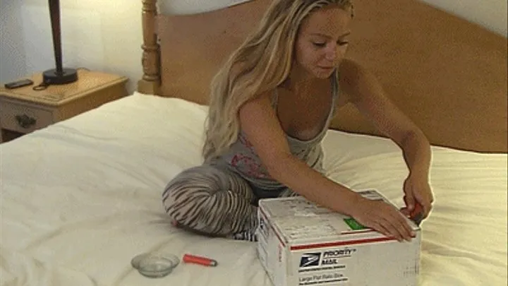 Petite Ashley opens her package