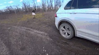 L O R Y pushes a car stuck in the mud I