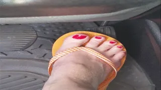 Pedal pumping in orange flip flops and barefoot