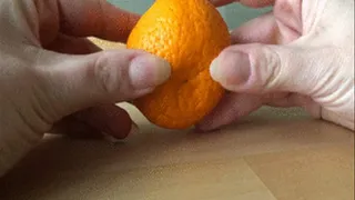 Nails digging into mandarin