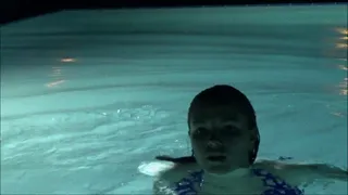 Magenta Holds Breath Underwater in Pool at Night