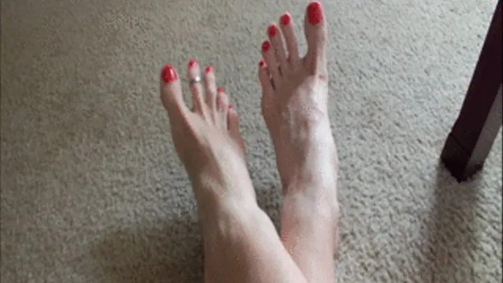 POV long freshly painted red toenails