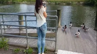 in jeans by the river