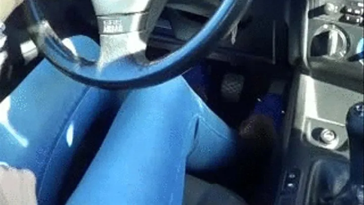 Secretary driving fast in blue ballerinas and blue jeans