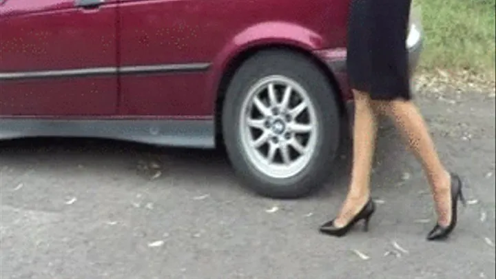 of Secretary REVVING hard her old BMW wearing her office stieltto pumps, stockings and short skirt