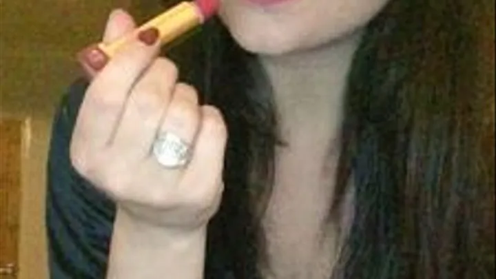 Applying red lipstick and smoking a cigarette