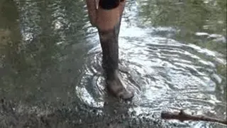 Brown rubber boots in the water walk
