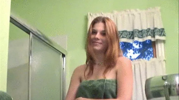 Pretty brunette showering and shaving in a tub