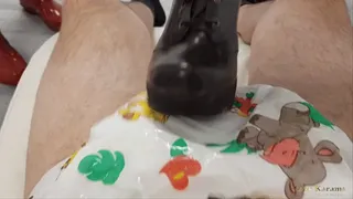 Man in diaper gets a double ballbusting treatment with hunter boots