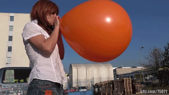 Titi blowing giant balloon outdoors