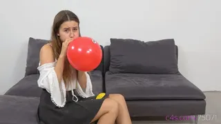 Cute Michelle is blowing up small party balloons