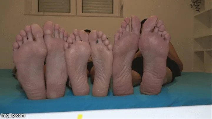 small foot of a man between two big woman feet