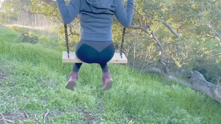 Bubble butt teenage girl shows off her thong on the swing set outdoors