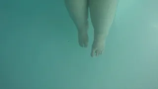 SSBBW Apple Bomb is showing off her feet underwater in a indoor pool