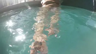 Juicy Jazmynne is showing off her feet underwater in a indoor pool
