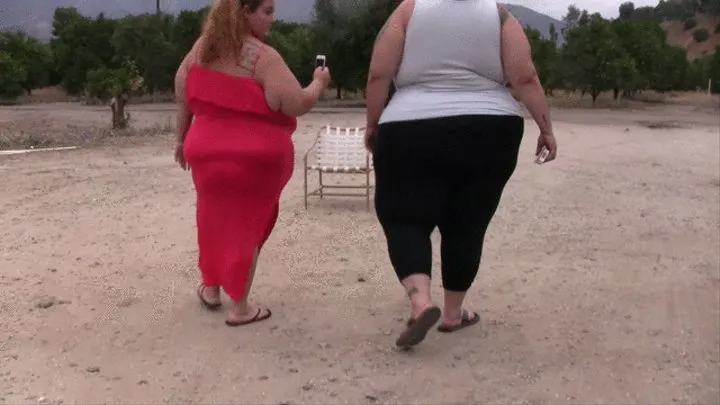 BBW Lola Love Bug and SSBBW Monika Mynx is smoking next to a trailer and walk around in the outdoors after their cigarette and they begin to kiss and make out and play with each others tits