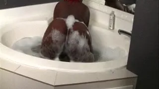 Marley is in the bathtub shaking her big butt and their are bubbles all over her ass