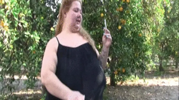 BBW Lola Love Bug is outdoors in a black dress smoking a cigarette and flashing her tits and ass and walking. She is blowing spoke out of her sexy lips.