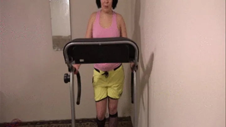 Girl running on the treadmill and undressing.