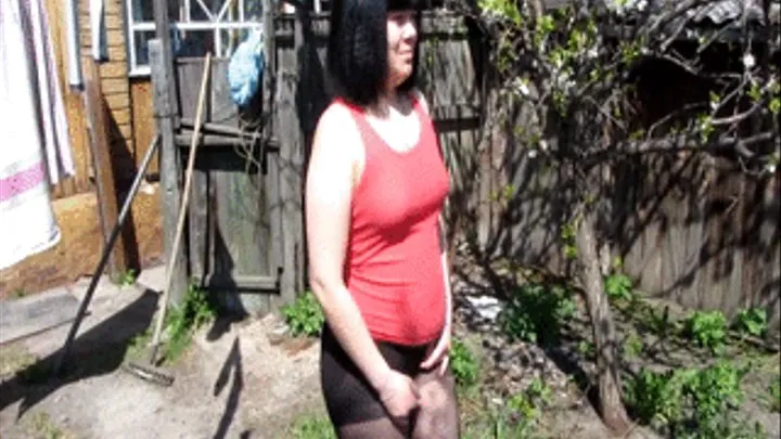 Girl in pantyhose pissing in the garden.