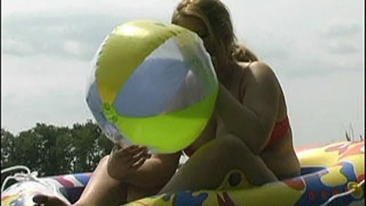 Kristy Blows A Beach Ball On The Beach