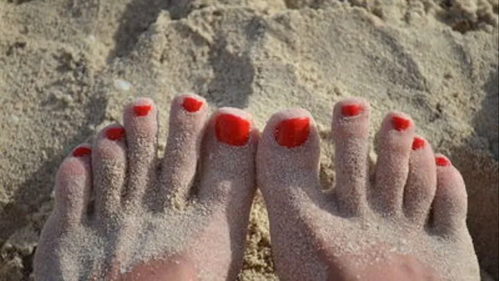 Red toes on sand