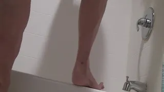 Tempest barefooted flexing on edge of tub