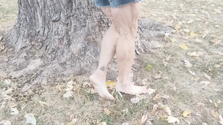 Tempest flexing barefoot by the tree