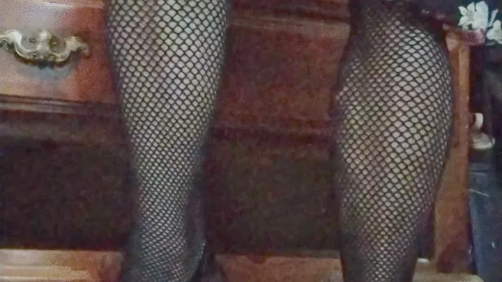 Flexing fishnets and red bottom heels