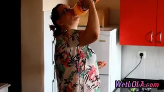 Mature woman drinks juice and pee all over the kitchen floor while playing with her pussy.