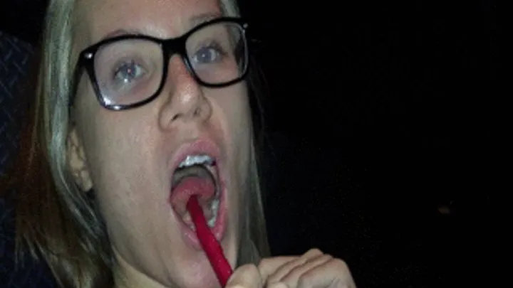 A naughty tease in the movie theatre - seductive candy eating, sucking, licking