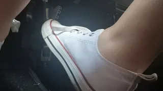 Driving with sexy white sneakers through the city of Milan