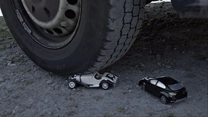 2 little cars under my giant tires