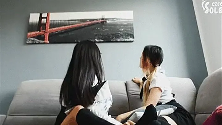 Two Asian schoolgirls foot fight and play