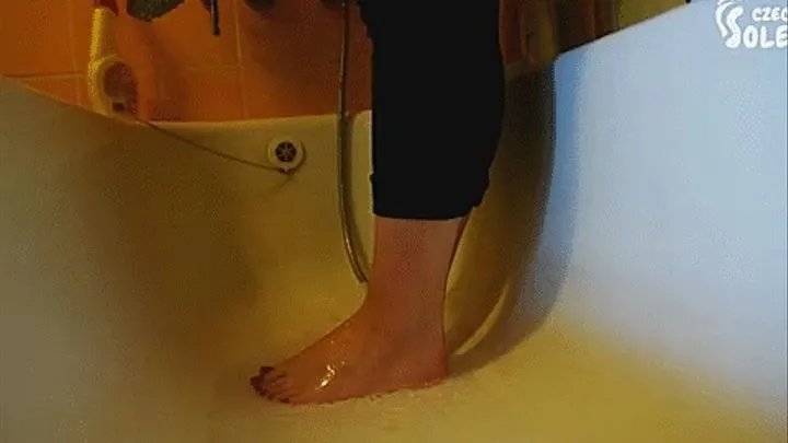 washing and brushing her bare feet