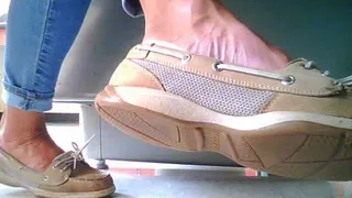 woman wearing boat shoes under office desk