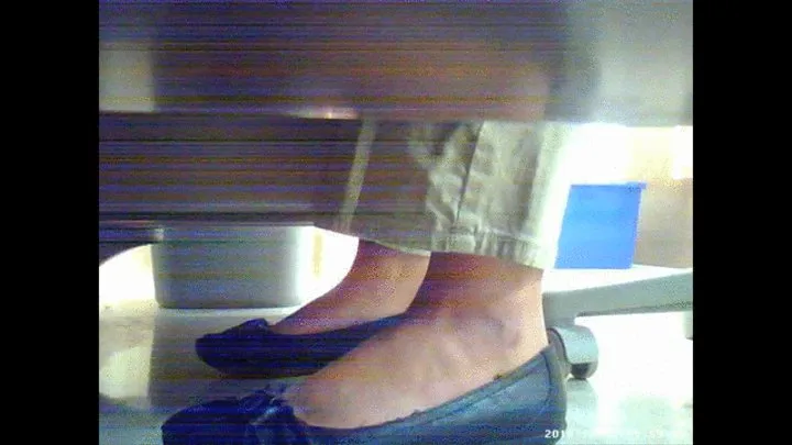 flats under a office desk and barefeet