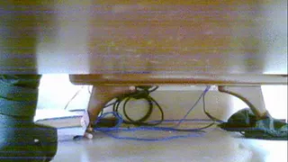black boots tapping under office desk