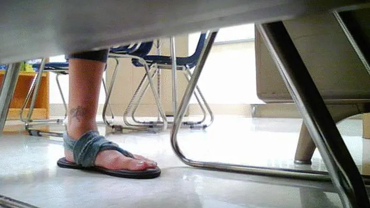 woman wearing blue flip flops under desk