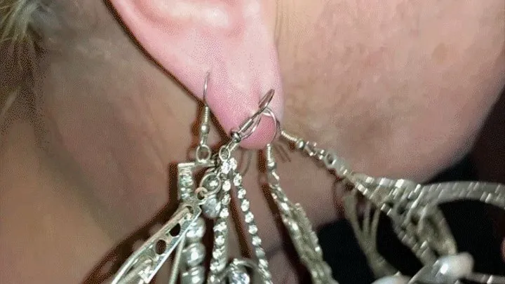 Many heavy earrings on one earlobe